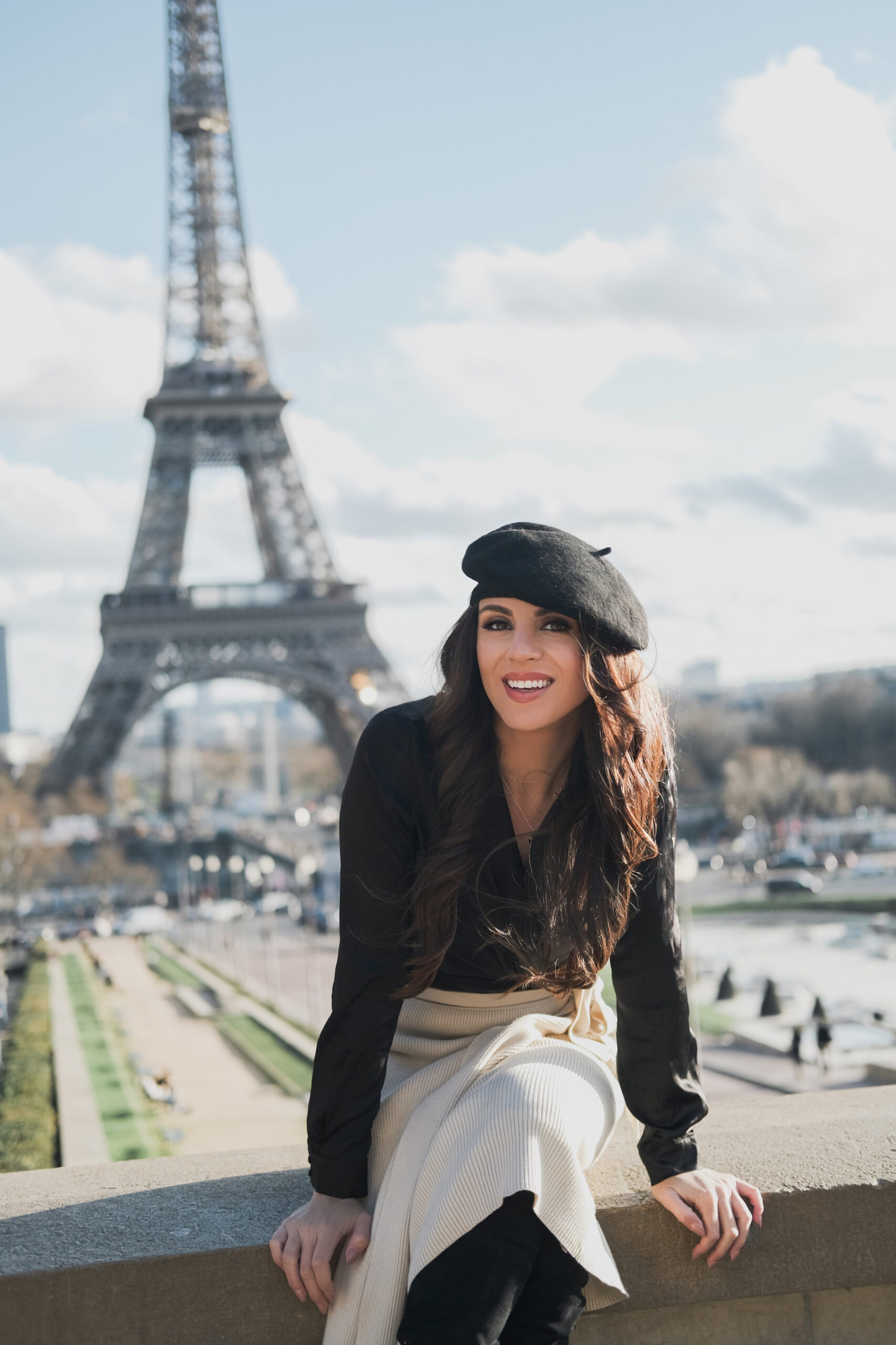 erica matchmaker smiling in Paris France standing at Eiffel tower